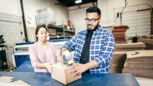 business owners taping box shut
