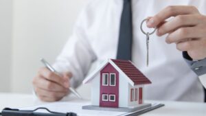 insurance agent holding keys to home for client