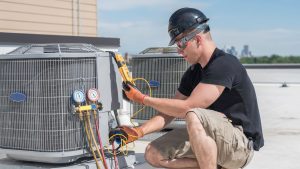 hvac technician testing air conditioning unit