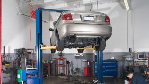 auto repair shop with image of car in the air on hoist