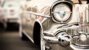 classic car image of headlight and chrome on grill