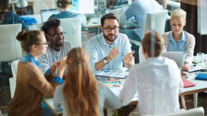 employees sitting around a table talking