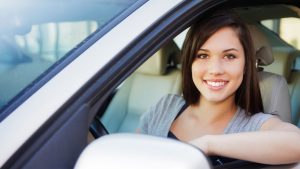 teen driver smiling while driving