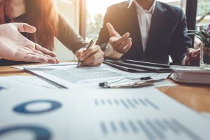 Business owner signing a contract